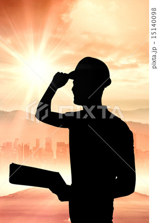 Composite image of manual worker wearing hardhat while holding c Composite image of manual worker wearing hardhat while holding c 15140098