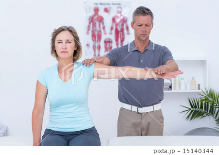 Doctor examining his patient arm Doctor examining his patient arm 15140344