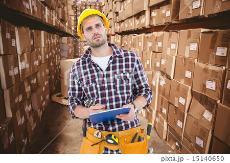 Composite image of thoughtful male repairman writing on clipboar Composite image of thoughtful male repairman writing on clipboar 15140650