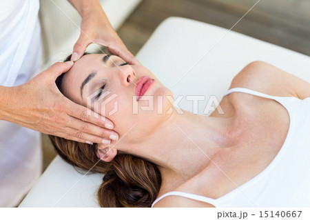 Calm woman receiving reiki treatment Calm woman receiving reiki treatment 15140667