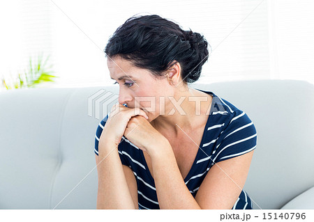 Unhappy woman sitting on the couch 15140796