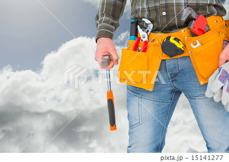 Composite image of manual worker holding gloves and hammer Composite image of manual worker holding gloves and hammer 15141277