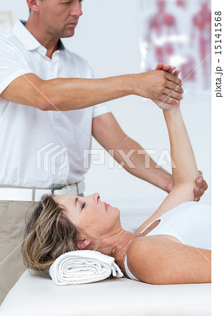 Doctor bending his patient arm 15141568