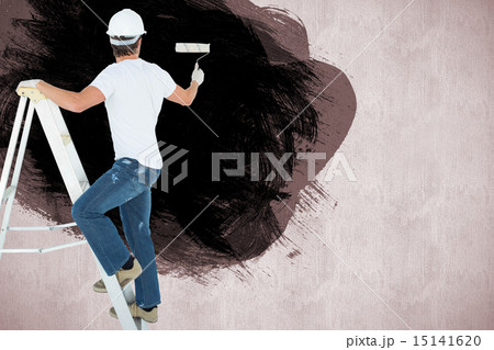 Composite image of man on ladder painting with roller 15141620