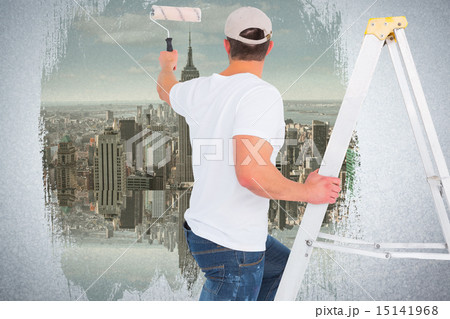 Composite image of handyman climbing ladder while using paint ro 15141968