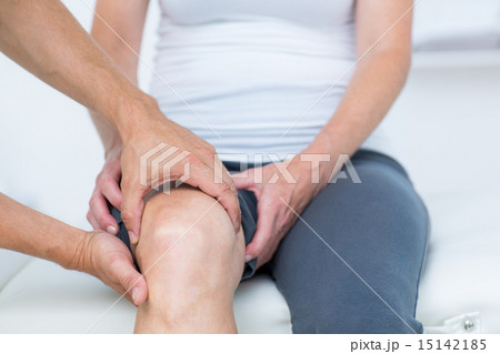 Doctor examining his patients knee Doctor examining his patients knee 15142185