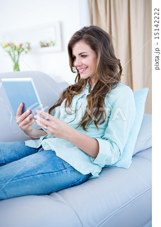 Pretty woman watching something on her tablet pc 15142222