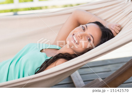 Pretty brunette relaxing on a hammock 15142570
