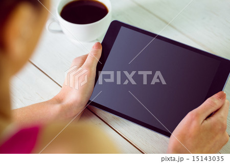 Woman using her tablet pc Woman using her tablet pc 15143035