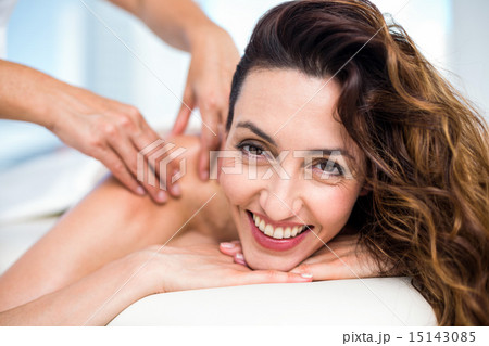 Smiling brunette getting back massage Smiling brunette getting back massage 15143085