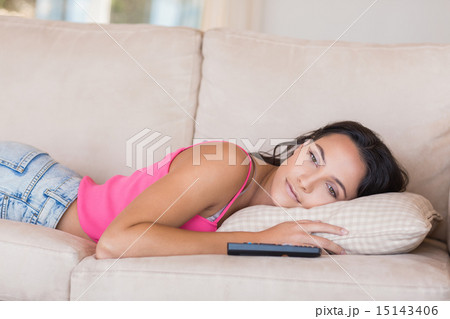 Pretty brunette relaxing on the couch 15143406