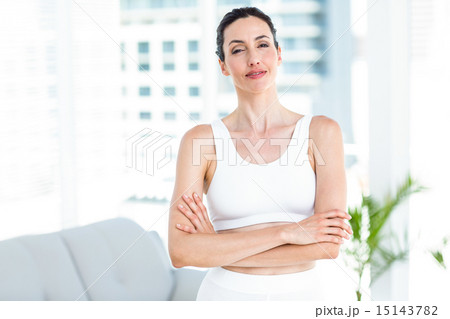 Smiling brunette wearing sportswear 15143782