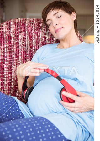 Pregnant woman relaxing on the couch Pregnant woman relaxing on the couch 15143814