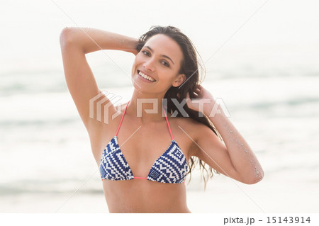Smiling pretty brunette posing in bikini Smiling pretty brunette posing in bikini 15143914