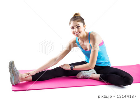Fit woman stretching on exercise mat Fit woman stretching on exercise mat 15144137