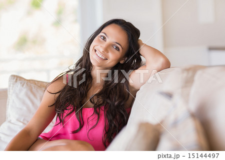 Pretty brunette relaxing on the couch 15144497