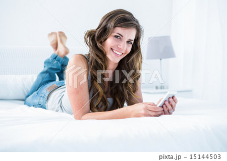Attractive woman using her smartphone 15144503