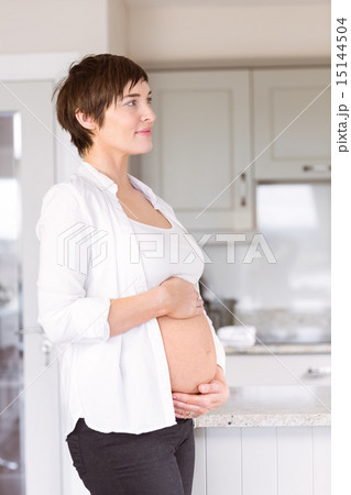 Pregnant woman holding her bump 15144504