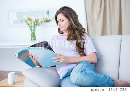 Peaceful woman reading a magazine 15144726