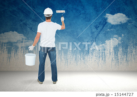 Composite image of rear view of man using paint roller Composite image of rear view of man using paint roller 15144727