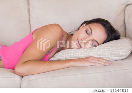 Pretty brunette relaxing on the couch 15144815