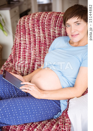 Pregnant woman using tablet pc Pregnant woman using tablet pc 15144882