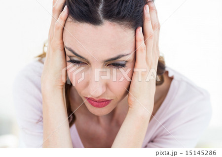 Sad brunette sitting on the couch 15145286