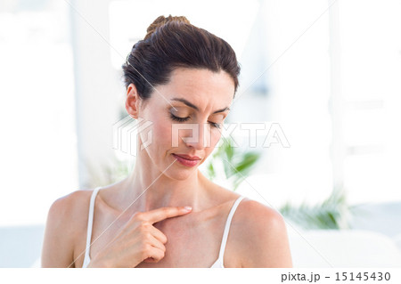 Brunette touching her clavicle 15145430