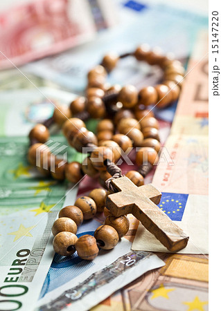 rosary beads on euro currency 15147220