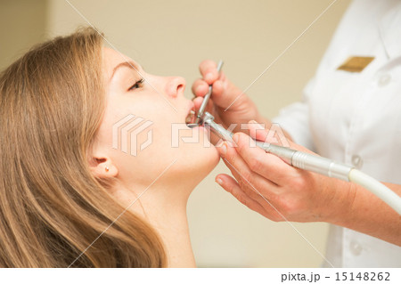 Dentist curing a female patient 15148262