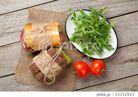 Two sandwiches with salad, ham, cheese 15152025