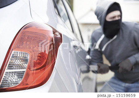 Masked Man Breaking Into Car With Crowbar 15159659