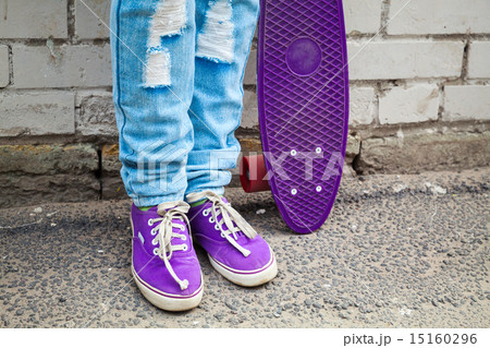 Teenager in jeans stands with skateboard Teenager in jeans stands with skateboard 15160296