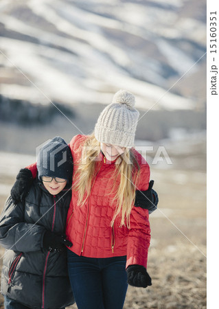 A brother and sister hugging and laughing together outdoors. A brother and sister hugging and laughing together outdoors. 15160351