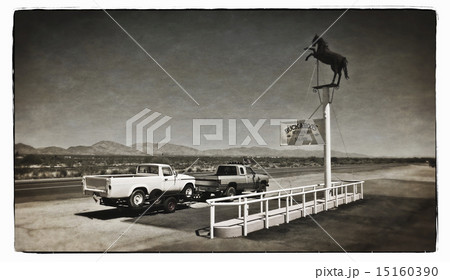 A truck towing a trailer parked at a roadside stop on a desert highway. A truck towing a trailer parked at a roadside stop on a desert highway. 15160390