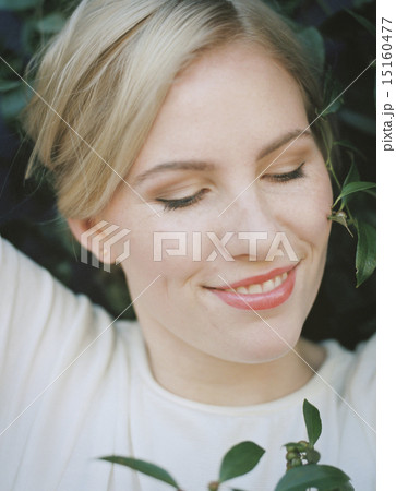 A pretty woman smiling with her eyes closed. 15160477
