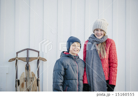 A brother and sister side by side in a yard in winter. A brother and sister side by side in a yard in winter. 15160555