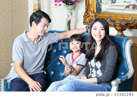 Parents and child on sofa 15162283