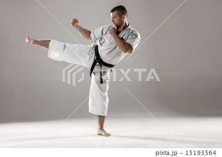 Man in white kimono training karate 15193564