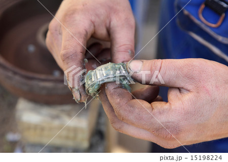 Car servicing, mechanic lubricate a roller bearing Car servicing, mechanic lubricate a roller bearing 15198224