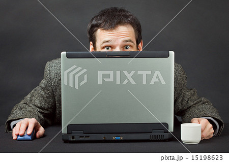 Frightened people hiding behind computer screen 15198623