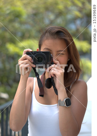 Young asian chinese girl with her photography hobby Young asian chinese girl with her photography hobby 15199689