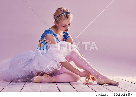 Professional ballerina putting on her ballet shoes. 15202387