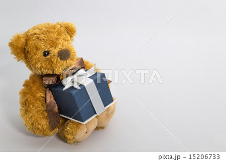 プレゼントを持つ子熊のぬいぐるみの写真素材