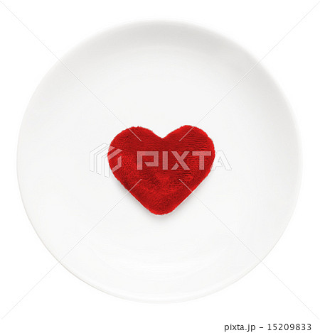 Red heart on a plate close-up isolated on a white background. Va 15209833