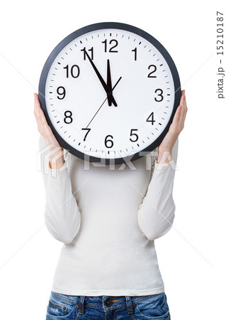 Woman holding a clock over face Woman holding a clock over face 15210187