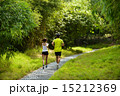 Man and girl are jogging buddy in the green park. 15212369