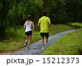 Man and girl are jogging buddy in the green park. 15212373