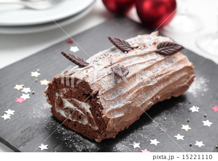 Yule log cake on a Christmas table Yule log cake on a Christmas table 15221110