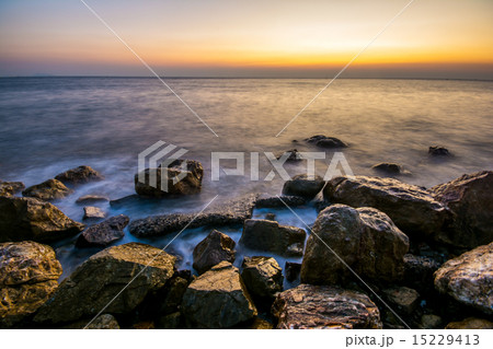 Beautiful sunset on beach with crashing waves Beautiful sunset on beach with crashing waves 15229413